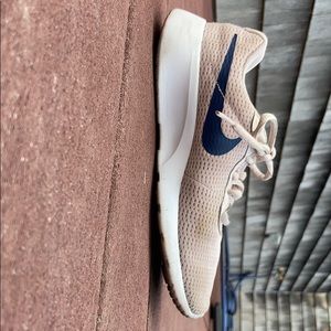 These are some girls pink and blue Nike shoes.